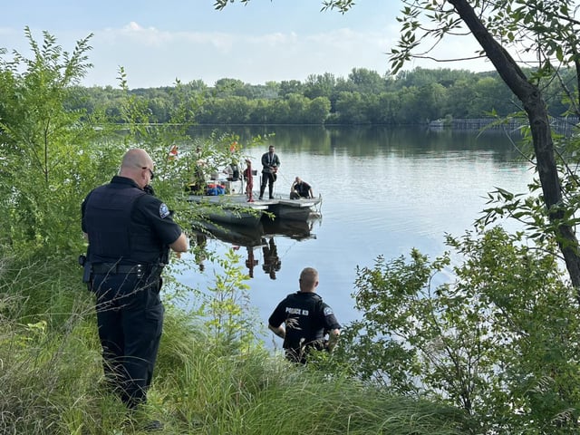 Officers from the Stearns County Sheriff's Office work to recovery the vehicle from the Mississippi River. 