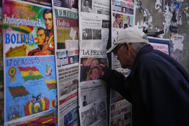 A man looks at newspapers front pages the day after presidential and legislative elections in La Paz, Bolivia, Monday, Aug. 18, 2025. (AP Photo/Juan Karita)