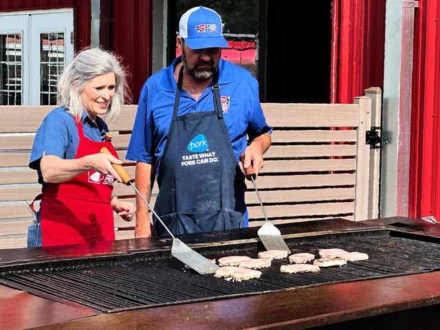 U.S. Sen. Joni Ernst flips pork chops at the Iowa State Fair in Des Moines, Iowa, on Tuesday, Aug. 12, 2025. (AP Photo/Hannah Fingerhut)