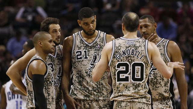 Spurs guard Manu Ginobili (20) talks with teammates (from left) Patrick Mills, and Marco Belinelli, and Tim Duncan, and Boris Diaw during the second half against the Charlotte Bobcats at AT&amp;T Center. The Spurs won 92-82