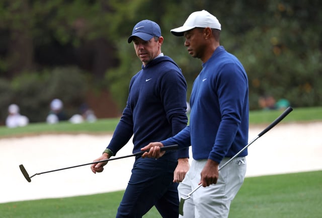 Golf - The Masters - Augusta National Golf Club - Augusta, Georgia, U.S. - April 3, 2023 Tiger Woods of the U.S. and Northern Ireland's Rory McIlroy REUTERS/Mike Blake/ File Photo