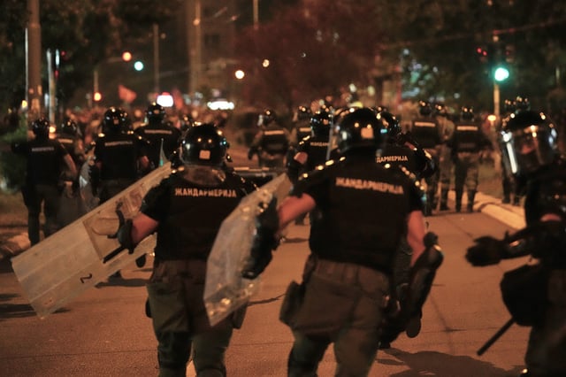 Serbian gendarmerie officers chase protesters during an anti-government protest in Belgrade, Serbia, Monday, Aug. 18, 2025. (AP Photo/Darko Vojinovic)