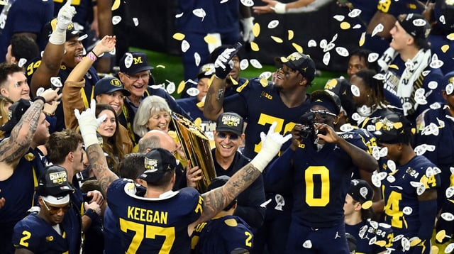 Jan 8, 2024; Houston, TX, USA; Michigan Wolverines head coach Jim Harbaugh holds the National Championship Trophy as he celebrates after winning 2024 College Football Playoff national championship game against the Washington Huskies at NRG Stadium. Mandatory Credit: Maria Lysaker-Imagn Images