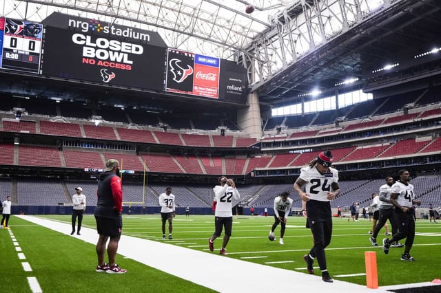 Houston Texans players warm up during an NFL training camp practice at NRG Stadium in Houston, Monday, Aug. 18, 2025.