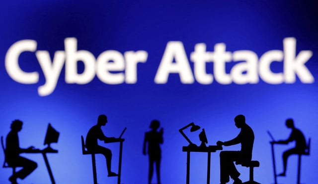 Figurines with computers and smartphones are seen in front of the words "Cyber Attack" in this illustration taken, February 19, 2024. REUTERS/Dado Ruvic/Illustration/File Photo