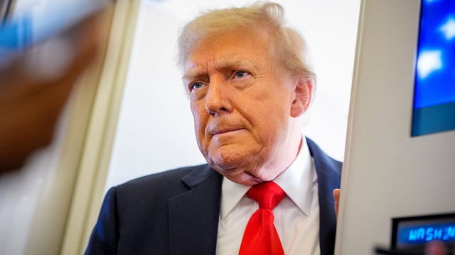 President Donald Trump takes a question from a reporter aboard Air Force One on August 15. (Photo: Andrew Harnik/Getty Images)