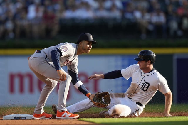 Detroit Tigers&#39; Colt Keith, right, slides against Houston Astros shortstop Jeremy Pena, left, to steal second base during the first inning of a baseball game, Monday, Aug. 18, 2025, in Detroit. (AP Photo/Ryan Sun)