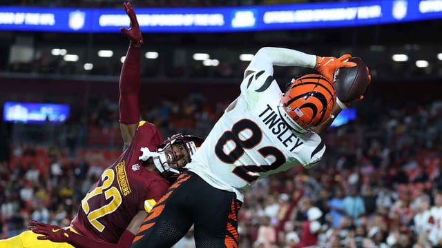 Cincinnati Bengals wide receiver Mitchell Tinsley (82) catches a touchdown pass over Washington Commanders cornerback Car&#39;lin Vigers (22) during the first half at Northwest Stadium. Mandatory Credit: Amber Searls-Imagn Images