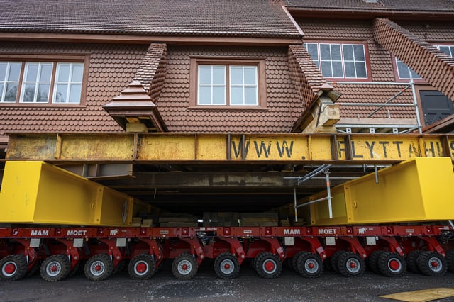 Beams placed on an wheeled structure support the Kiruna Church, a Sami style wooden Swedish Lutheran church, called Kiruna Kyrka in Swedish, in Kiruna, Sweden, Monday, Aug. 18, 2025, a day before it will be moved along a 5-kilometer (3-mile) route east to a new city center as part of the town's relocation.(AP Photo/Malin Haarala)