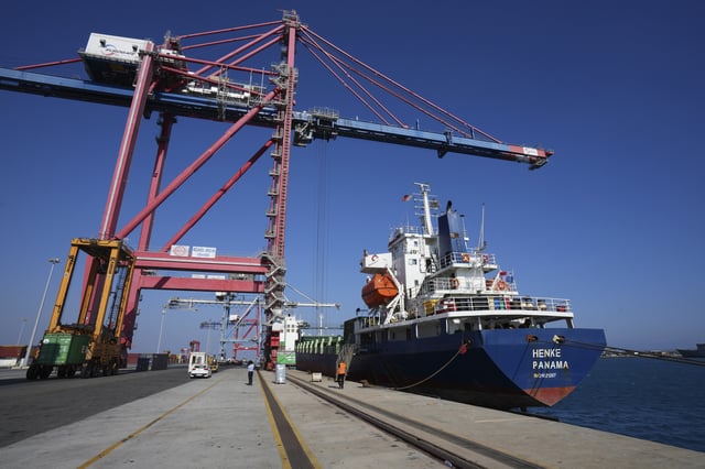 Containers loaded with humanitarian aid for the people of Gaza, including flour, pasta, baby food and canned goods, is being loaded aboard a Panamanian-flagged ship at Cyprus' main port in Limassol, on Monday, Aug. 18, 2025. (AP Photo/Petros Karadjias)