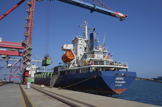 Containers loaded with humanitarian aid for the people of Gaza, including flour, pasta, baby food and canned goods, is being loaded aboard a Panamanian-flagged ship at Cyprus' main port in Limassol, on Monday, Aug. 18, 2025. (AP Photo/Petros Karadjias)