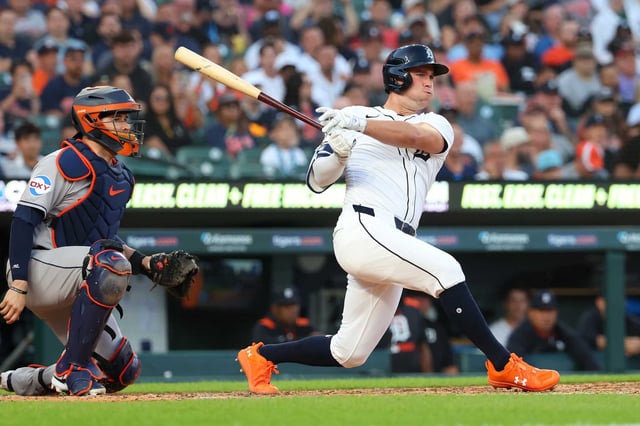 Kerry Carpenter (30) of the Detroit Tigers hits a fifth inning triple that scores two runs in front of Victor Caratini (17) of the Houston Astros at Comerica Park on Monday, Aug. 18, 2025, in Detroit.
