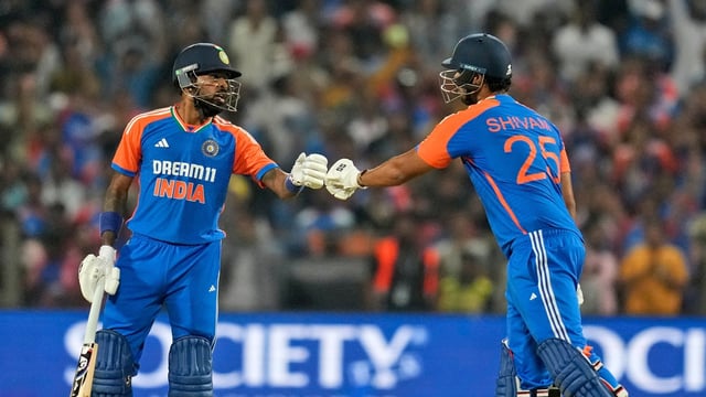 India's Hardik Pandya, left, and teammate Shivam Dube touch gloves