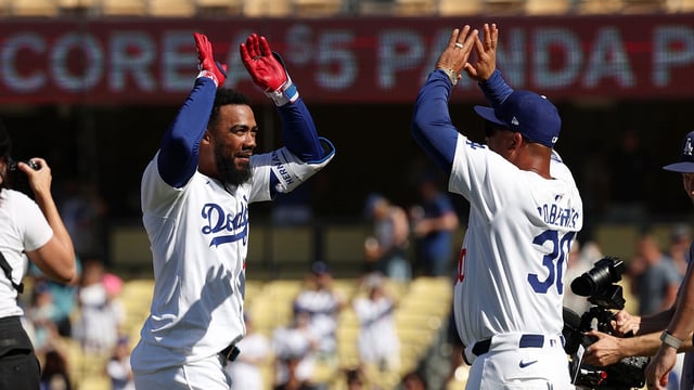 Aug 11, 2024; Los Angeles, California, USA; Los Angeles Dodgers left fielder Teoscar Hernandez (37) celebrates with manager Dave Roberts (30) after hitting a game winning RBI single in bottom of the tenth inning against the Pittsburgh Pirates at Dodger Stadium. Mandatory Credit: Kiyoshi Mio-Imagn Images