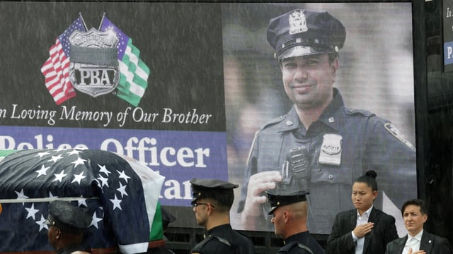 Police officers carry the coffin of New York City Police Department (NYPD) officer Didarul Islam, killed during a mass shooting event at a midtown Manhattan office tower on July 28, in the rain, during his funeral services in the Bronx borough of New York City, U.S., July 31, 2025 REUTERS/Jeenah Moon