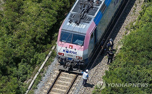 Police, firefighters and KORAIL officials inspect a rail track where a passenger train struck seven workers conducting safety inspections in the southeastern county of Cheongdo on Aug. 19, 2025. (Yonhap)