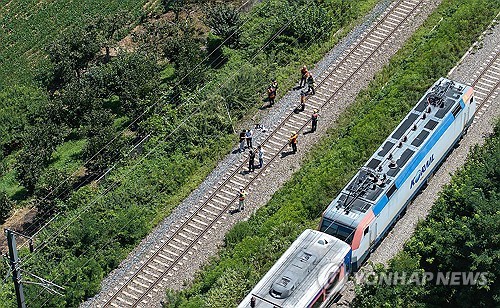 Police, firefighters and KORAIL officials inspect a railway track where a passenger train struck seven workers conducting safety inspections in the southeastern county of Cheongdo on Aug. 19, 2025. (Yonhap)