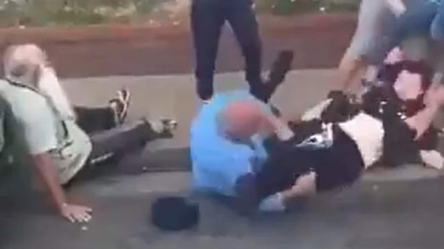 One of the victims can be seen in the video laying on the floor without his turban, while another can be seen getting kicked and punched.