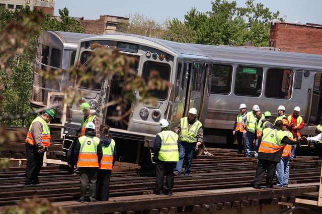 Chicago Transit Authority (CTA) workers survey a train after it derailed south of downtown in this archive stock photo from May 2008 in Chicago, Illinois. Only minor injuries were reported following that incident.