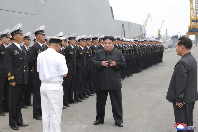 In this photo provided by the North Korean government, North Korean leader Kim Jong Un, center, inspects the warship Choe Hyon in Nampo, North Korea, on August 18, 2025.