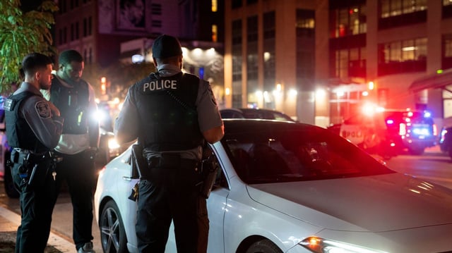 Law enforcement officers near a stopped vehicle on U Street in D.C. on Saturday. Photo: Stefani Reynolds/Bloomberg via Getty Images