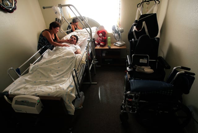 File photo: a woman tends to her husband who is suffering from Valley Fever in California.