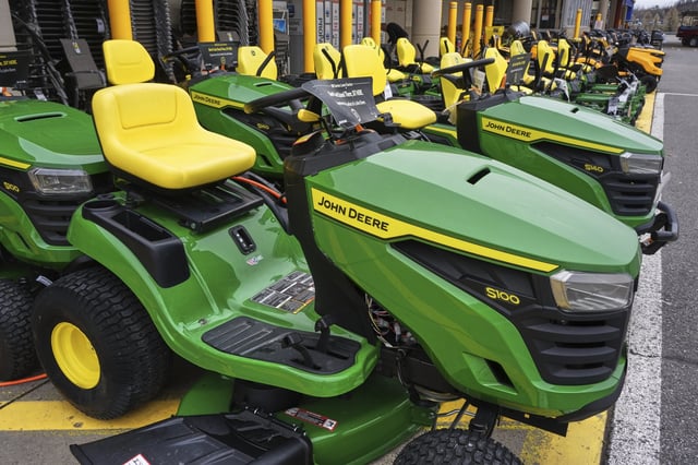 John Deere lawn tractors sit on display outside a Home Depot in Robinson Township, Pa., Friday, April 11, 2025.