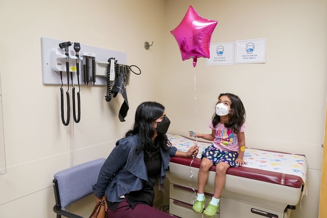 Shivani Agarwal, left, sits with her daughter daughter Kiran, 3, during the observation period after Kiran was inoculated with the first dose of the Moderna COVID-19 vaccine for children 6 months through 4 years old, Tuesday, June 21, 2022, at Montefiore Medical Group in the Bronx borough of New York. (AP Photo/Mary Altaffer)