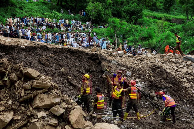 Residents gather as rescue workers look for victims, following a storm that caused heavy rains and flooding in Dalori Bala village in Gadoon district in Khyber Pakhtunkhwa province, Pakistan, August 19, 2025. REUTERS/Akhtar Soomro