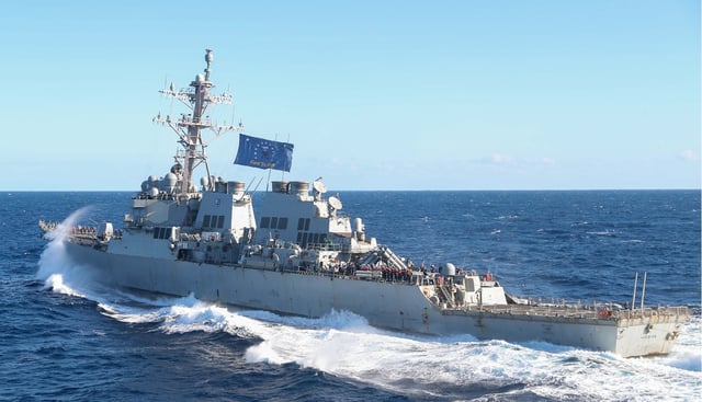 Arleigh Burke-class guided-missile destroyer USS Higgins (DDG 76) pulls away from Nimitz-class aircraft carrier USS George Washington (CVN 73) after conducting a fueling-at-sea while underway in the Pacific Ocean, November 7, 2024.