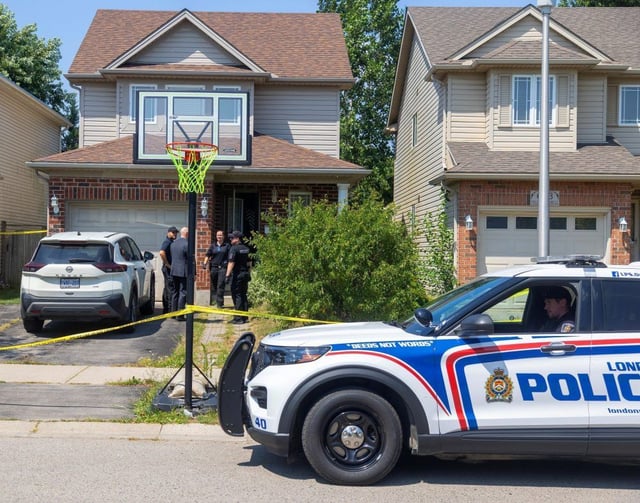 Forensic officers and a plainclothes officer speak in front of 657 Fieldgate Circle in east London after a shooting on Monday, August 11, 2025. (Mike Hensen/The London Free Press)