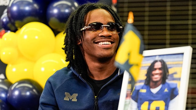 Michigan signee Bryce Underwood smiles during national signing day at Belleville High School in Belleville on Wednesday, Dec. 4, 2024.