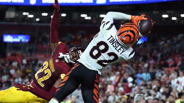 Aug 18, 2025; Landover, Maryland, USA; Cincinnati Bengals wide receiver Mitchell Tinsley (82) catches a touchdown pass over Washington Commanders cornerback Car&#39;lin Vigers (22) during the first half at Northwest Stadium. Mandatory Credit: Amber Searls-Imagn Images