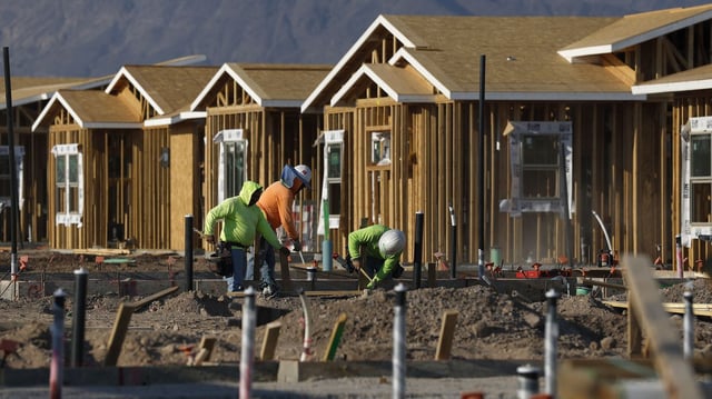Construction workers build homes at a new housing development earlier this month in Nevada. Photo: Justin Sullivan/Getty Images