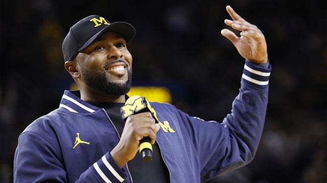 Jan 19, 2025; Ann Arbor, Michigan, USA; Michigan Wolverines head football coach Sherrone Moore fires up the crowd in overtime of the basketball game against the Northwestern Wildcats at Crisler Center. Mandatory Credit: Rick Osentoski-Imagn Images