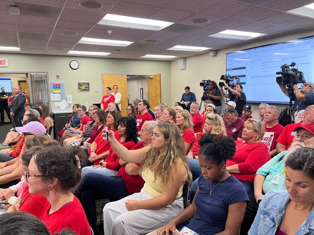 Naperville School District 203 teachers, wearing red for education, packed the Monday night school board meeting. They were there to protest the district&#39;s failure to negotiate a new contract with the teachers union despite collective bargaining sessions having started in February. (Michelle Mullins)