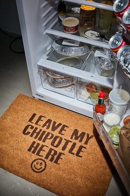 Pieces from the Urban Outfitters x Chipotle "A Little Extra" Dorm Collection. The Chipotle Delivery Doormat is $19.