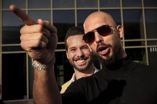 Andrew Tate gestures, next to his brother Tristan, outside the Bucharest Tribunal in Bucharest, Romania on Jan. 9, 2025.