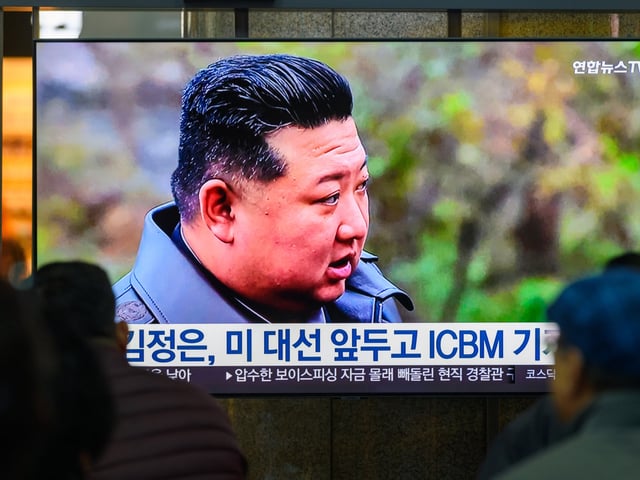 SEOUL, SOUTH KOREA - 2024/10/23: A 24-hour Yonhapnews TV broadcast at Yongsan Railway Station in Seoul showing North Korean leader Kim Jong Un visiting a strategic missile base at an undisclosed location in North Korea. North Korean leader Kim Jong Un urged enhancing the country's war deterrence, including nuclear readiness, citing growing U.S. nuclear threats, state media reported on October 23. During an inspection of a strategic missile base, Kim reviewed its capabilities and operational readiness. The location and date of the inspection were not disclosed. (Photo by Kim Jae-Hwan/SOPA Images/LightRocket via Getty Images)