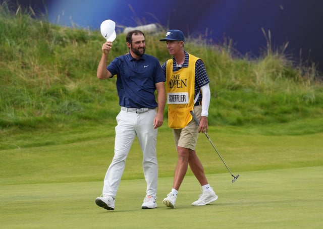 Golf - The 153rd Open Championship - Royal Portrush Golf Club, Portrush, Northern Ireland, Britain - July 20, 2025 Scottie Scheffler of the U.S. celebrates on the 18th green with his caddie Ted Scott after winning The 153rd Open Championship REUTERS/Maja Smiejkowska/ File Photo