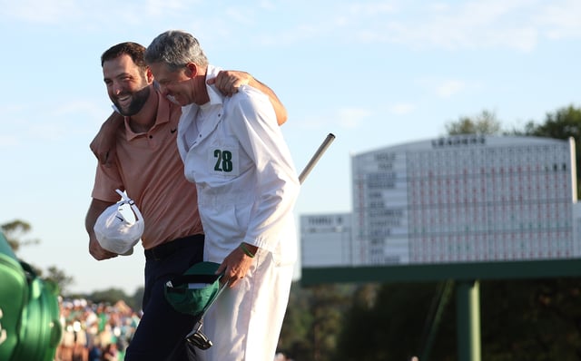Scottie Scheffler of the United States and caddie Ted Scott celebrate on the 18th green after winning the 2024 Masters Tournament at Augusta National Golf Club on April 14, 2024 in Augusta, Georgia.