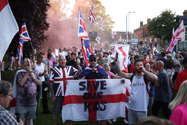 Protesters calling for the closure of the The Bell Hotel gather outside the council offices in Epping on August 8 (Photo by HENRY NICHOLLS / AFP)