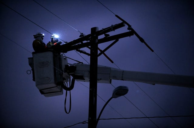 This is a file photo of Xcel Energy employees working on a utility pole on Stanford Avenue in Englewood.