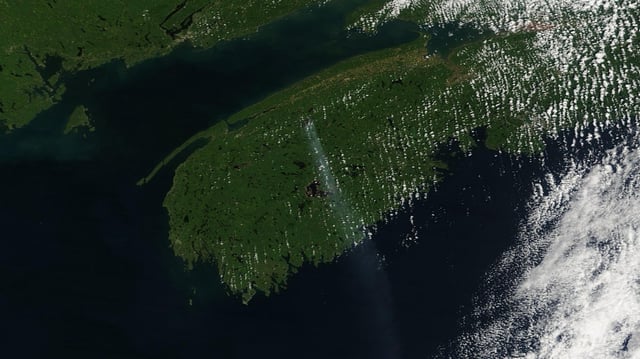 A trail of smoke from the Long Lake wildfire, burning in Nova Scotia's Annapolis County, is seen in this handout satellite image, on Monday, Aug. 18, 2025. THE CANADIAN PRESS/Handout - NASA Worldview (Mandatory Credit)