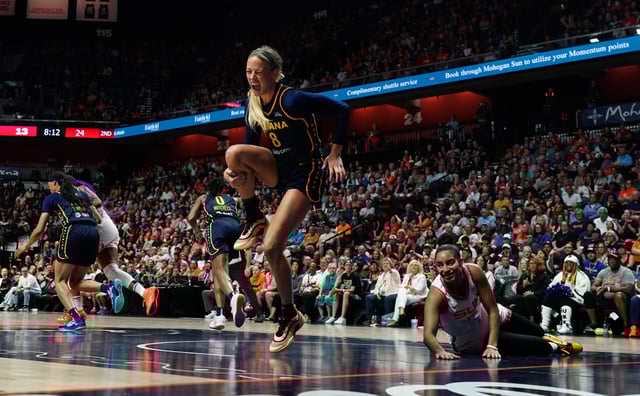 Aug 17, 2025; Uncasville, Connecticut, USA; Indiana Fever guard Sophie Cunningham (8) is injured on a play against Connecticut Sun guard Bria Hartley (14) in the first half at Mohegan Sun Arena. Mandatory Credit: David Butler II-Imagn Images