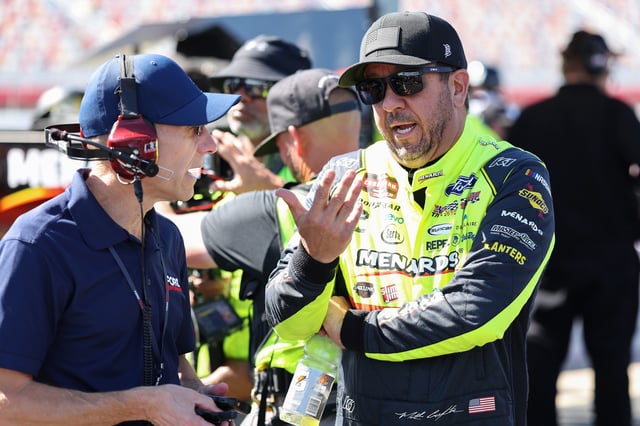Matt Crafton, driver of the #88 Chi Chis/Menards Ford, speaks to a crew member during practice for the NASCAR Craftsman Truck Series North Carolina Education Lottery 200 at Charlotte Motor Speedway on May 23, 2025 in Concord, North Carolina.