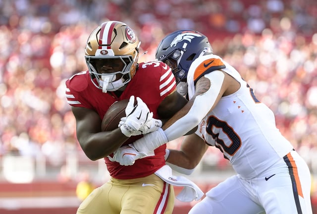 ANTA CLARA, CALIFORNIA - AUGUST 09: Justin Strnad #40 of the Denver Broncos tackles Patrick Taylor Jr. #32 of the San Francisco 49ers in first half of an NFL Preseason 2025 game at Levi&#39;s Stadium on August 09, 2025 in Santa Clara, California. (Photo by Thearon W. Henderson/Getty Images)