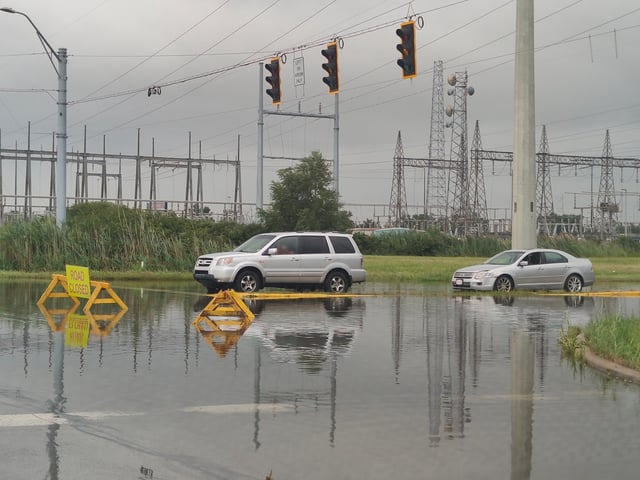 Cars wait in standing water on the west side of the 129th Street and Calumet Avenue intersection in Hammond on Tuesday morning after heavy rains overnight. (Christin Nance Lazerus/Post-Tribune)
