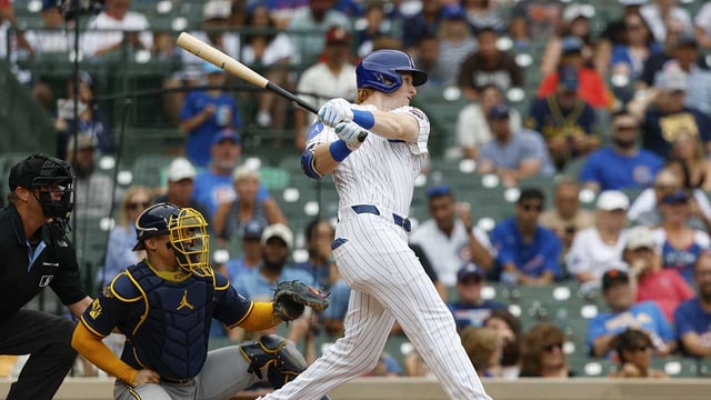 Aug 19, 2025; Chicago, Illinois, USA; Chicago Cubs right fielder Owen Caissie (19) hits a solo home run against the Milwaukee Brewers during the sixth inning of the game one of the doubleheader at Wrigley Field. Mandatory Credit: Kamil Krzaczynski-Imagn Images