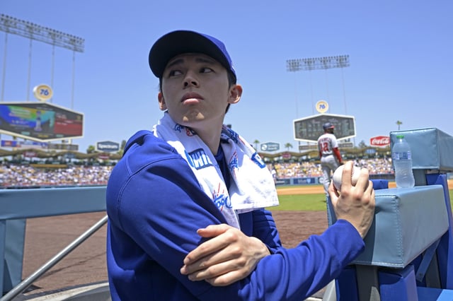 LOS ANGELES, CALIFORNIA - JUNE 22: Roki Sasaki #11 of the Los Angeles Dodgers looks on from the dugout during the game against the Washington Nationals at Dodger Stadium on June 22, 2025 in Los Angeles, California. (Photo by Jayne Kamin-Oncea/Getty Images)